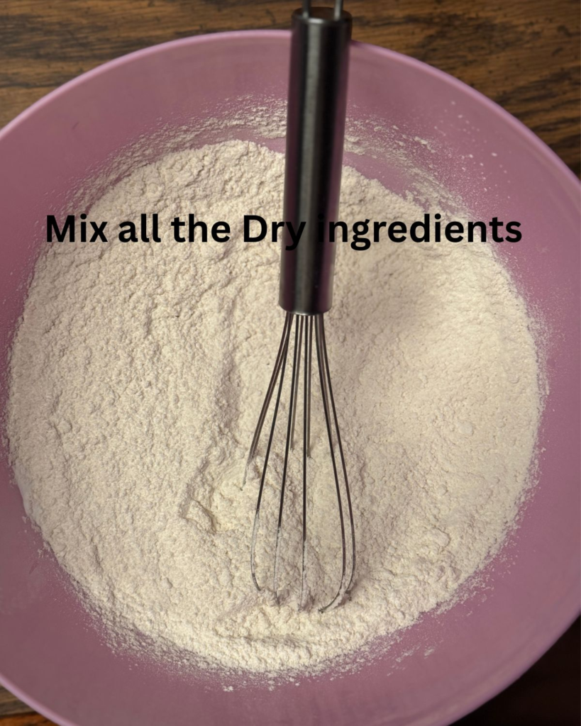 Whisking dry ingredients for easy buttermilk pancakes in a pink mixing bowl before adding wet ingredients.