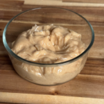 Easy Texas Roadhouse whipped honey cinnamon butter in a glass bowl on a wooden cutting board
