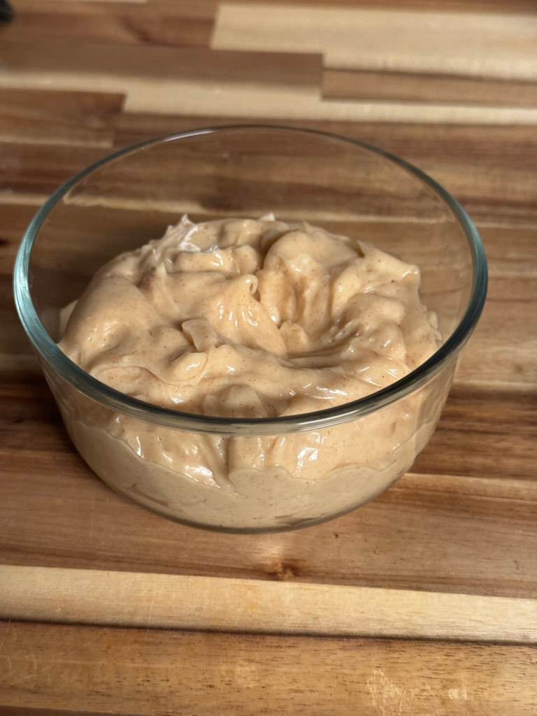 Easy Texas Roadhouse whipped honey cinnamon butter in a glass bowl on a wooden cutting board