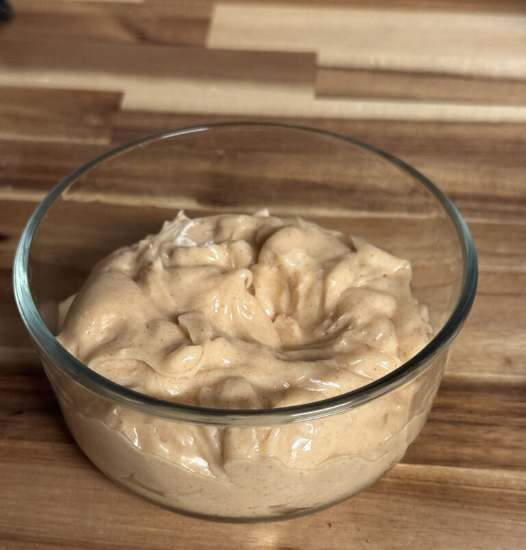 Easy Texas Roadhouse whipped honey cinnamon butter in a glass bowl on a wooden cutting board
