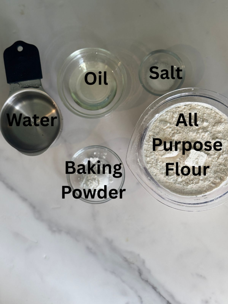 Ingredients for homemade flour tortillas including all purpose flour, baking powder, salt, oil, and water