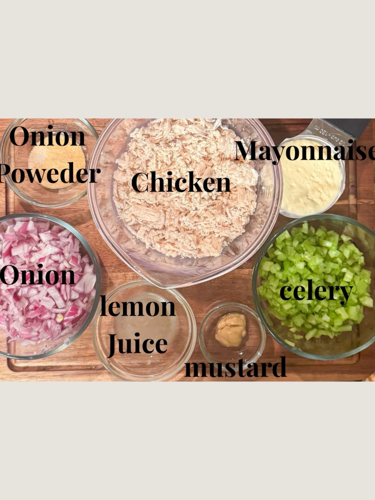 Ingredients for classic chicken salad including shredded chicken, mayonnaise, celery, red onion, mustard, lemon juice, and onion powder
