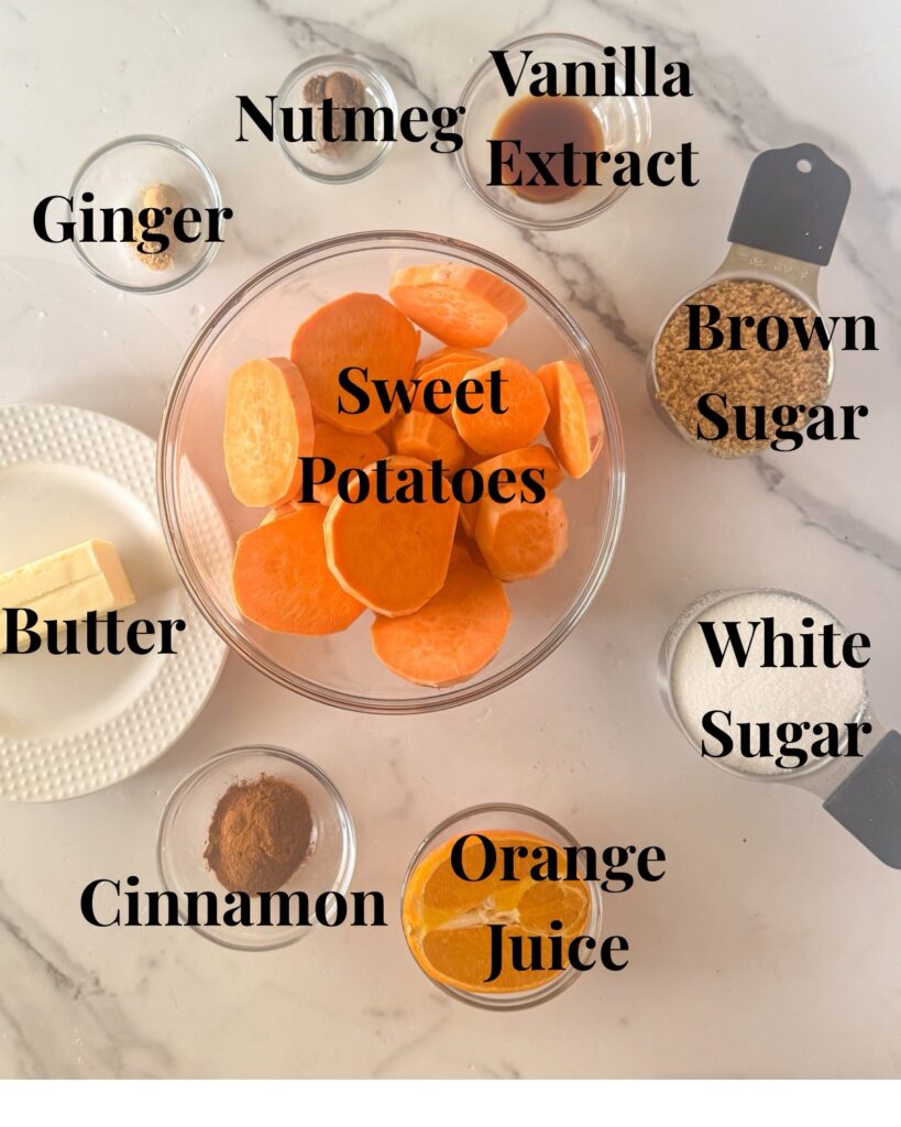 Ingredients for southern candied sweet potatoes including sliced sweet potatoes, butter, brown sugar, white sugar, cinnamon, nutmeg, vanilla, and orange on a marble surface