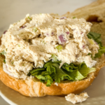 Classic homemade chicken salad served on a soft bun with fresh lettuce and creamy texture