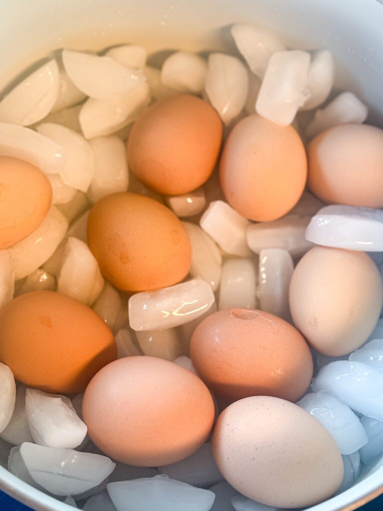 Hard boiled eggs cooling in an ice bath to stop cooking and make peeling easier
