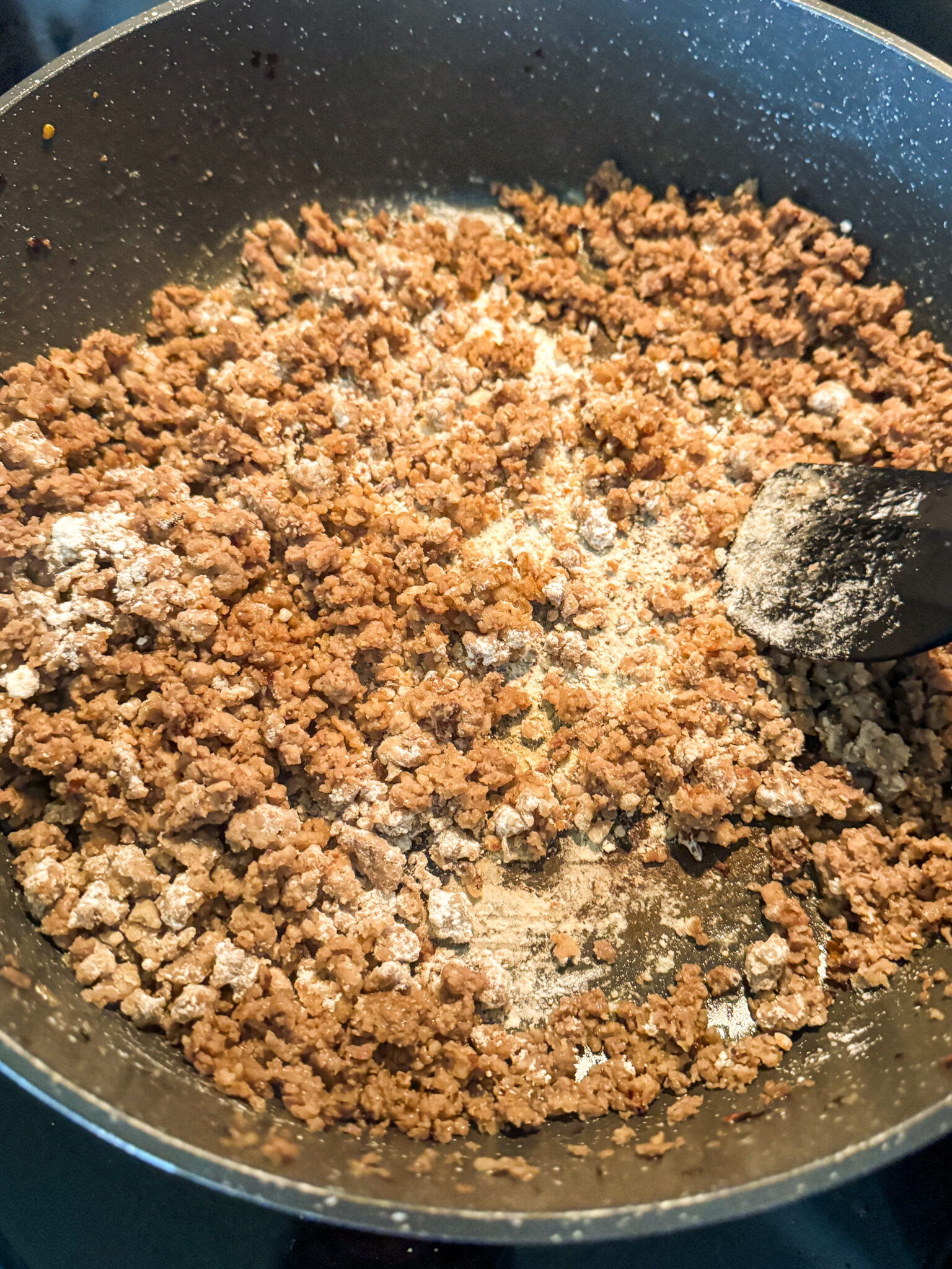 Adding Flour to Sausage for Gravy adding flour to cooked sausage to make homemade sausage gravy roux
